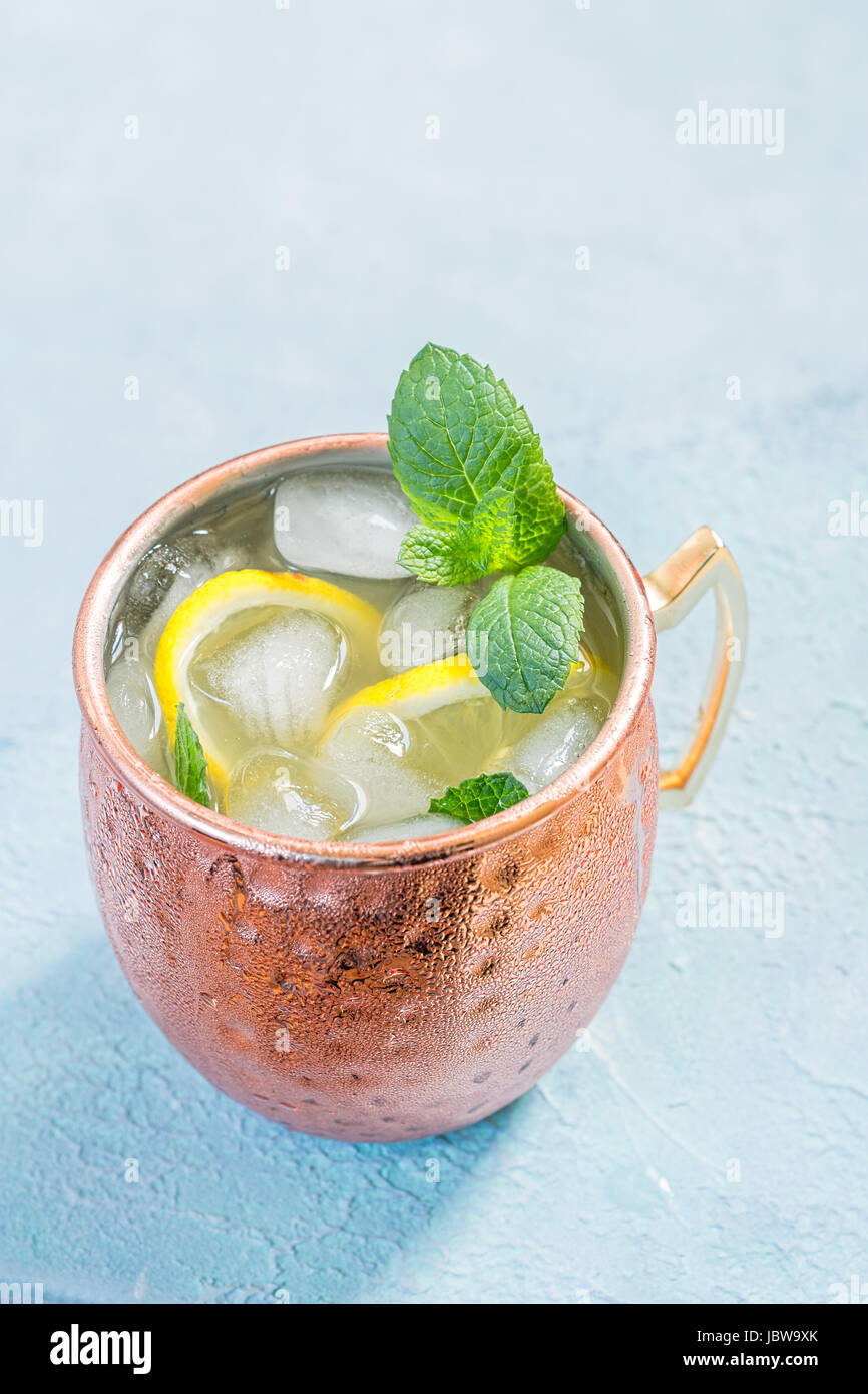 Cold Moscow Mules cocktail with ginger beer, vodka and lemon Stock Photo