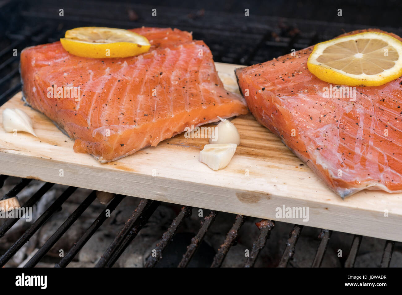 cedar plank salmon with lemon cooking on grill Stock Photo Alamy