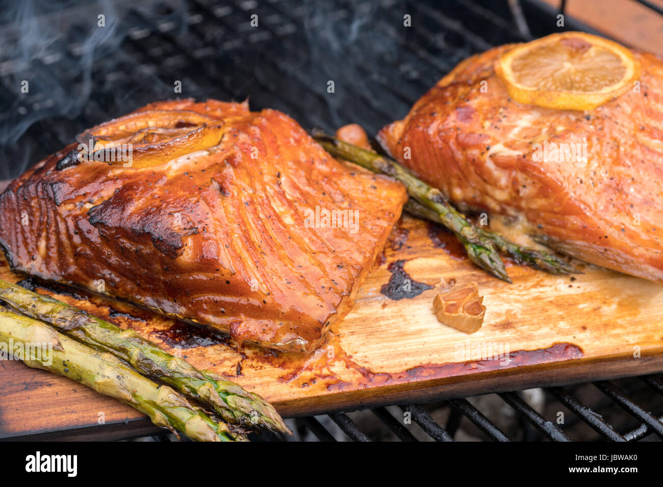cedar plank salmon with lemon cooking on grill Stock Photo Alamy