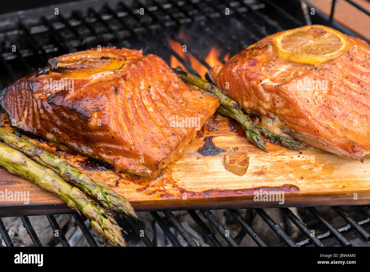 cedar plank salmon with lemon cooking on grill Stock Photo Alamy