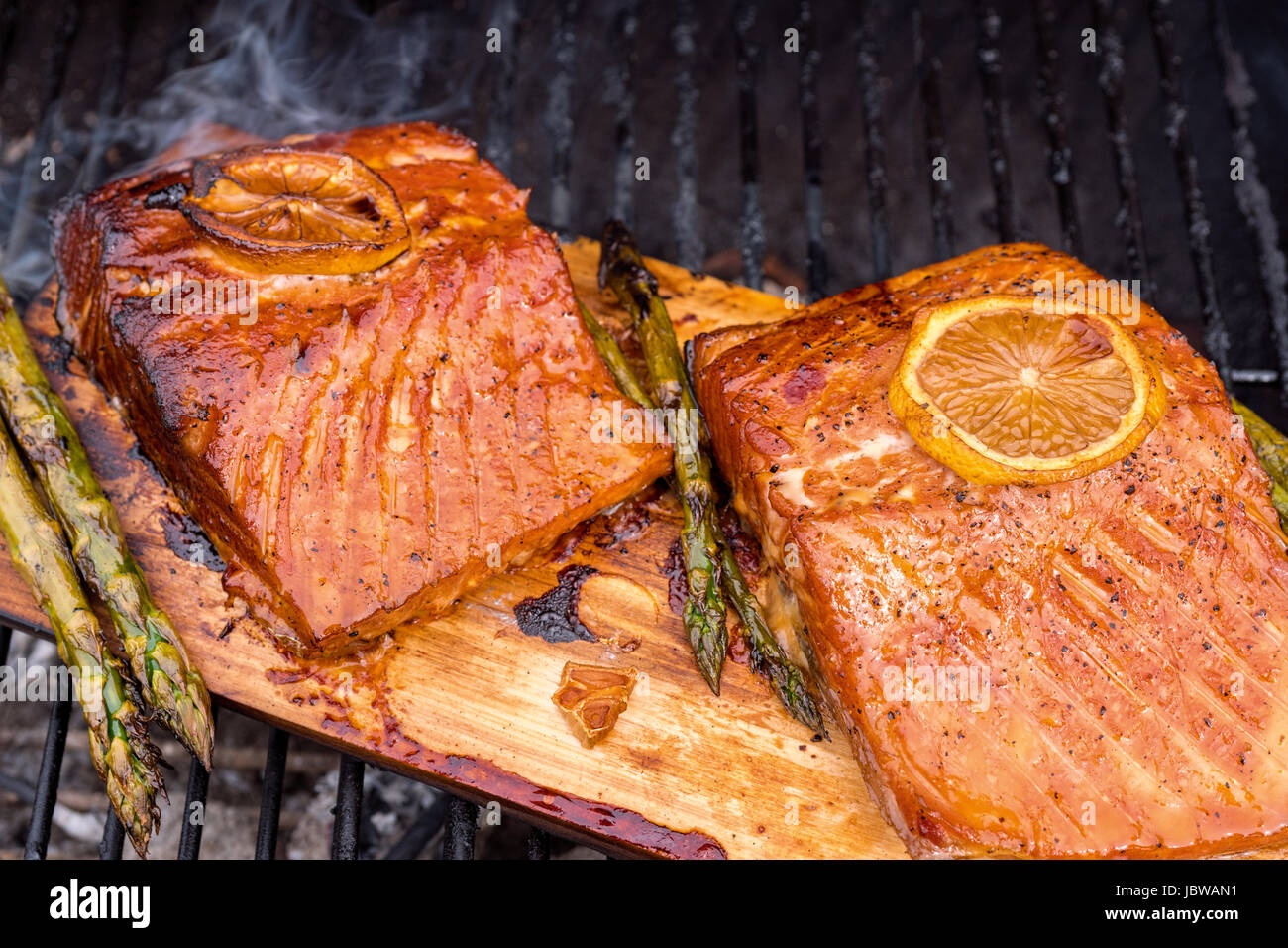 cedar plank salmon with lemon cooking on grill Stock Photo Alamy