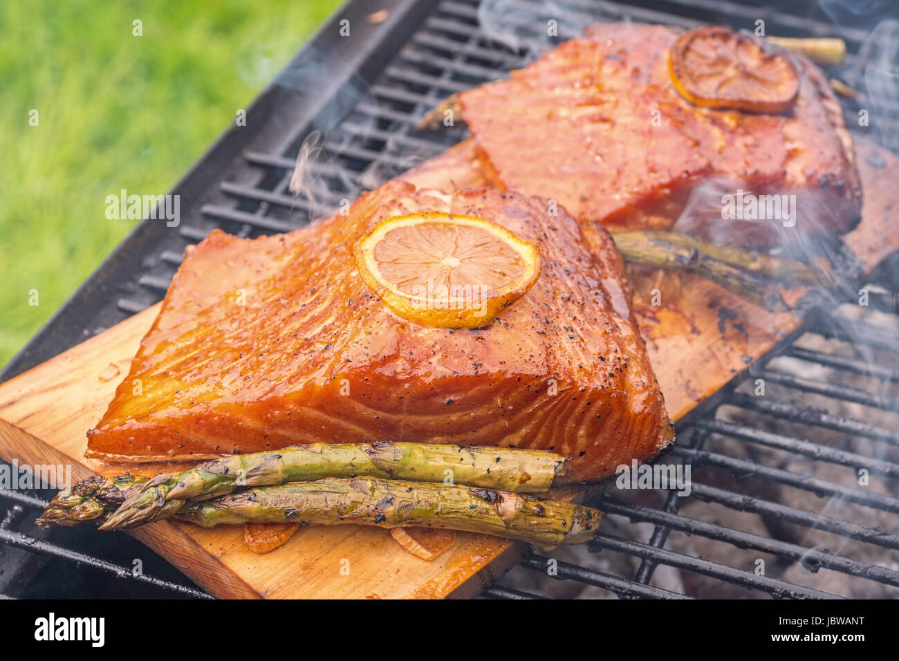 cedar plank salmon with lemon cooking on grill Stock Photo Alamy