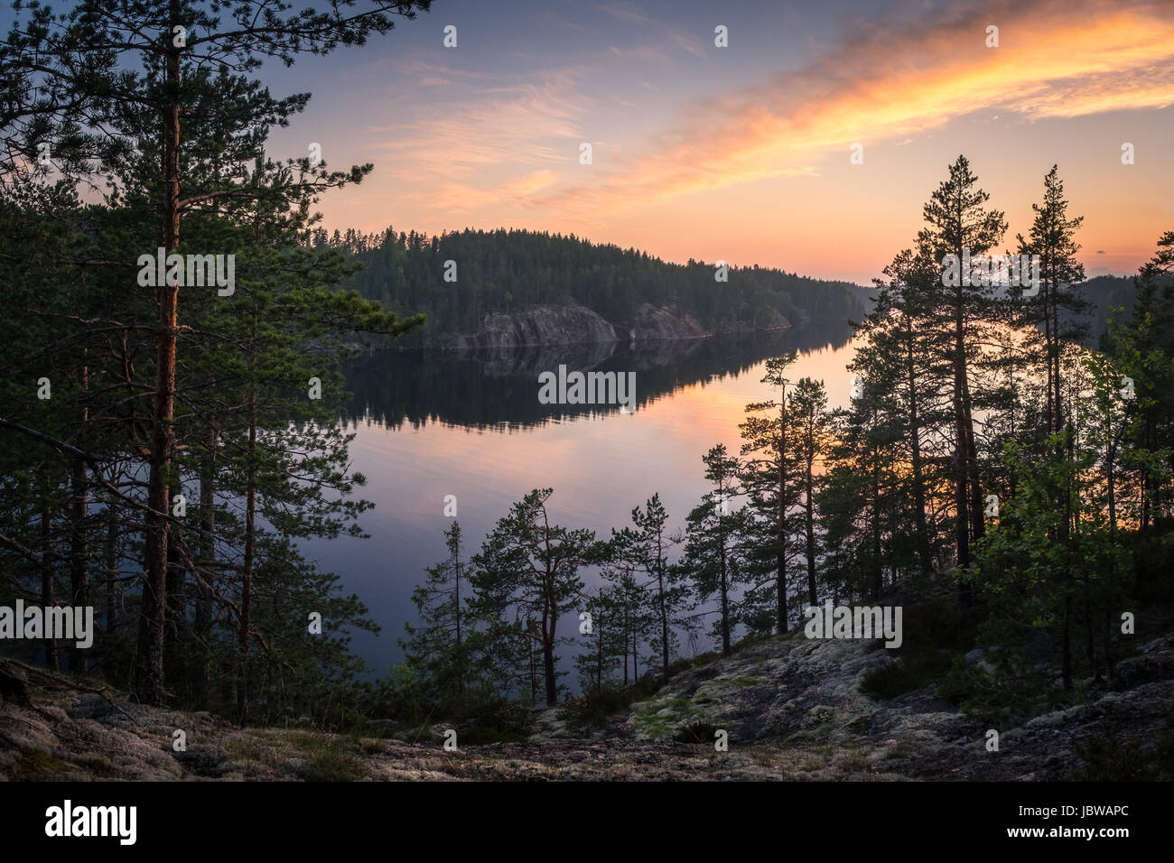 Scenic landscape with sunset and lake at summer evening in Finland Stock Photo
