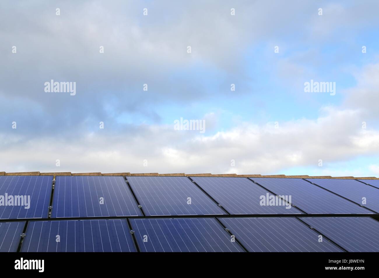 Solar panels on a house roof, with sky background Stock Photo - Alamy