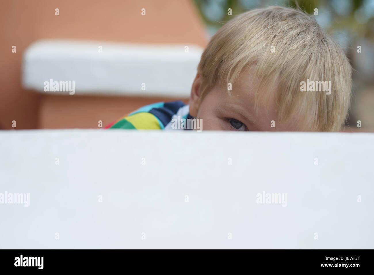 Prying Up Prying little boy looking up onto wall Stock Photo - Alamy