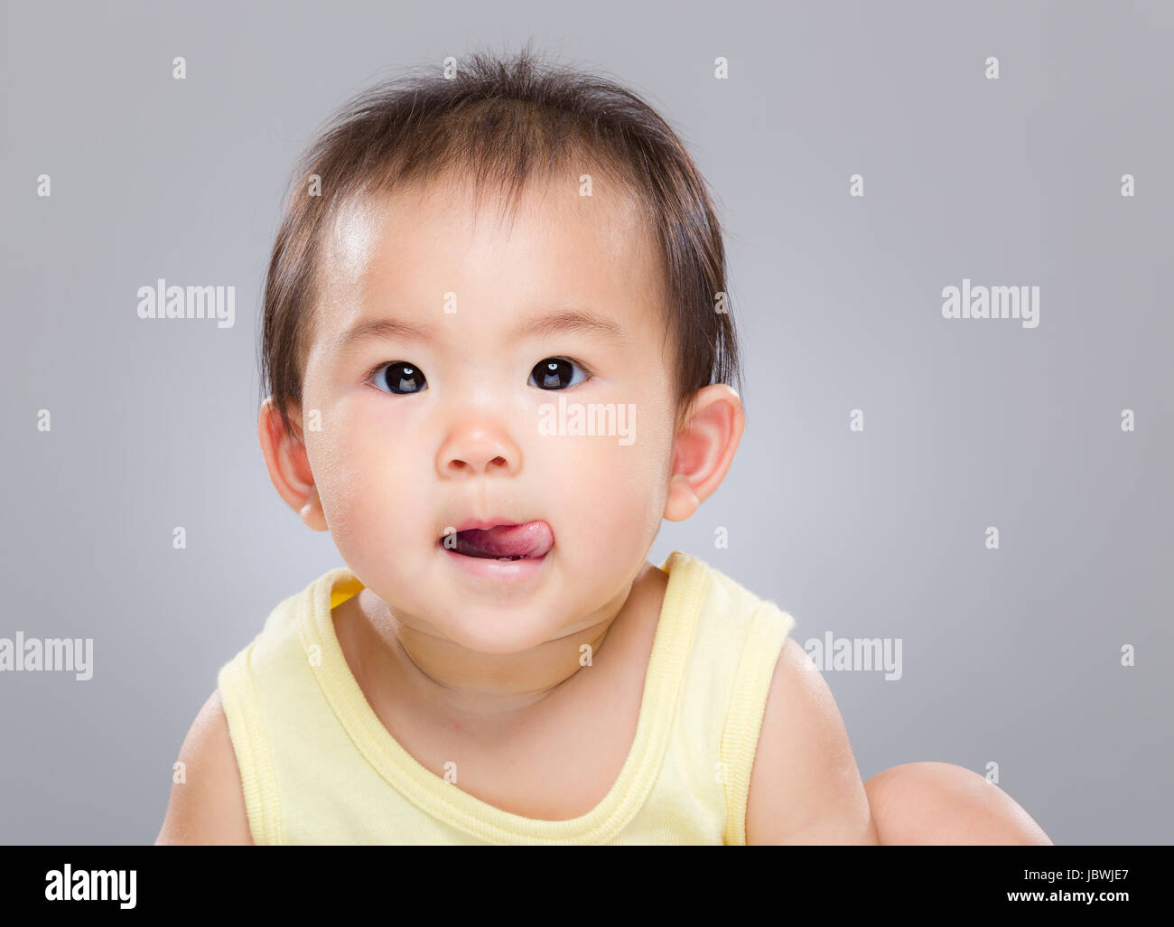 Baby girl sticking tongue out Stock Photo Alamy