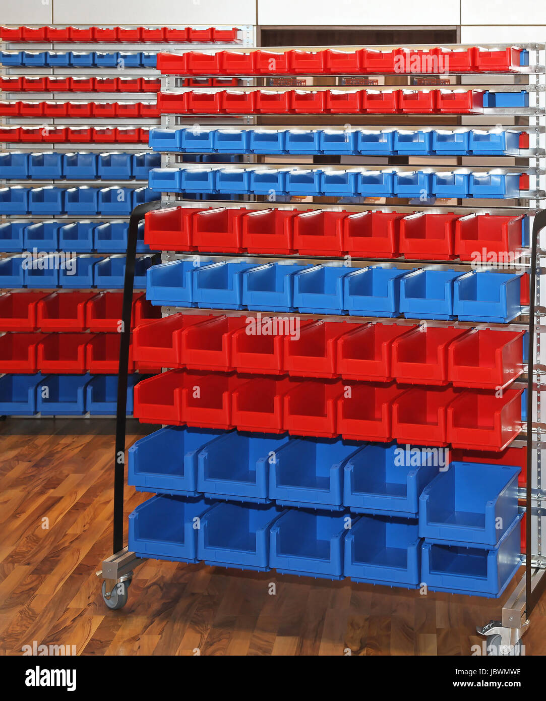 Blue and red mobile rolling storage cart in warehouse Stock Photo