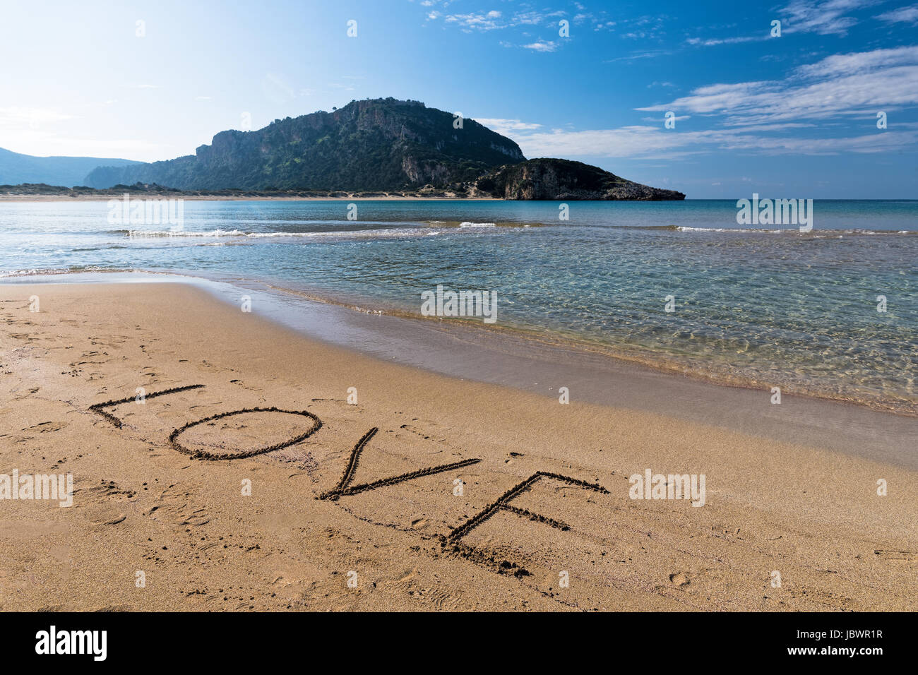 The word 'love', written on the sand of the famous Voidokilia beach in Peloponnese, one of the most beautiful beaches in Greece Stock Photo