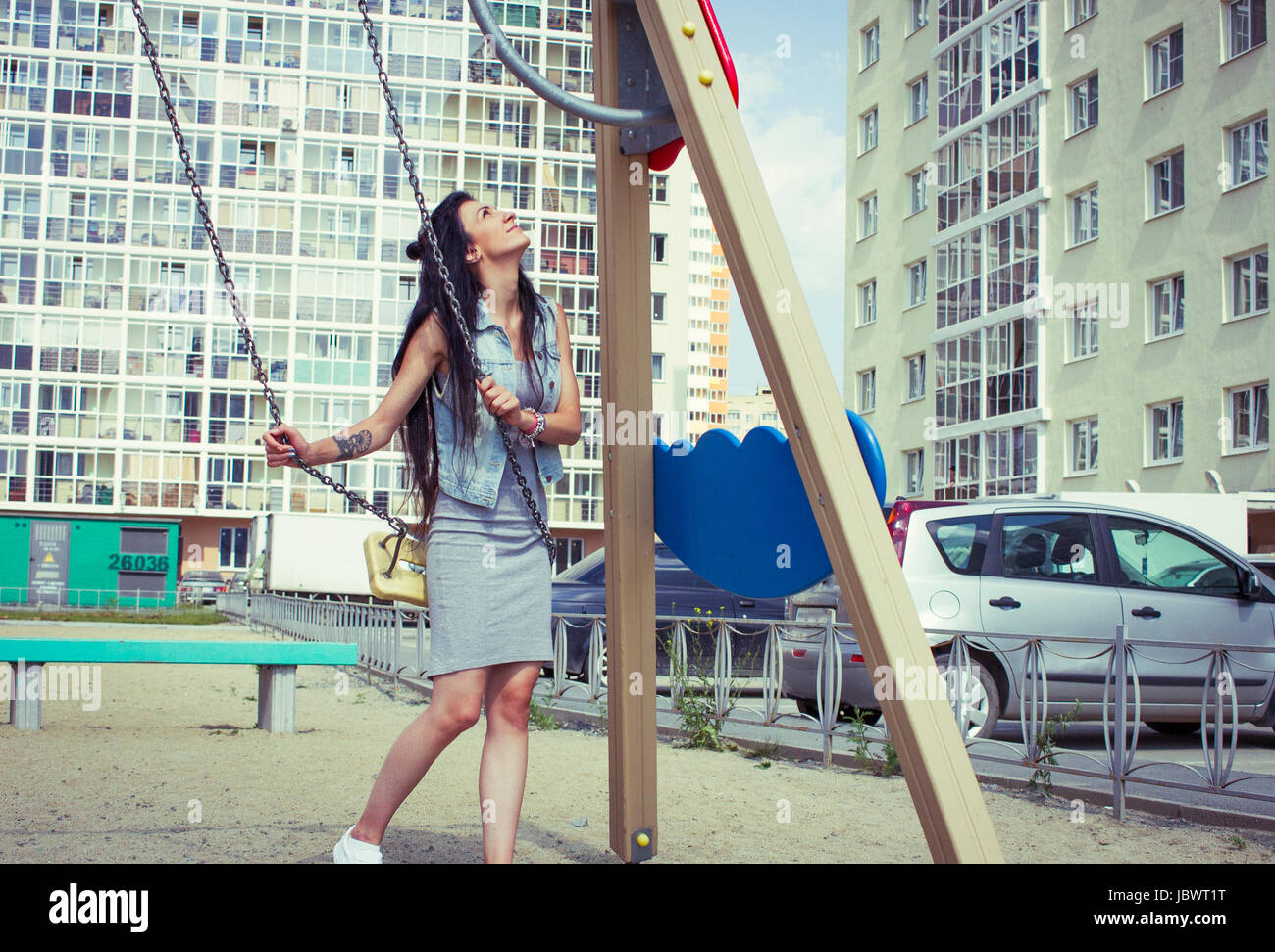 Woman on playground swing Stock Photo