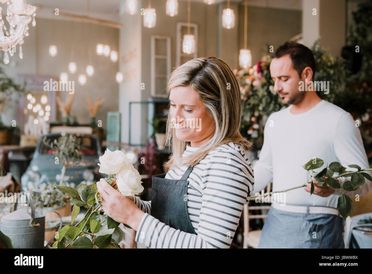 Two florists in flower shop, arranging flowers Stock Photo - Alamy