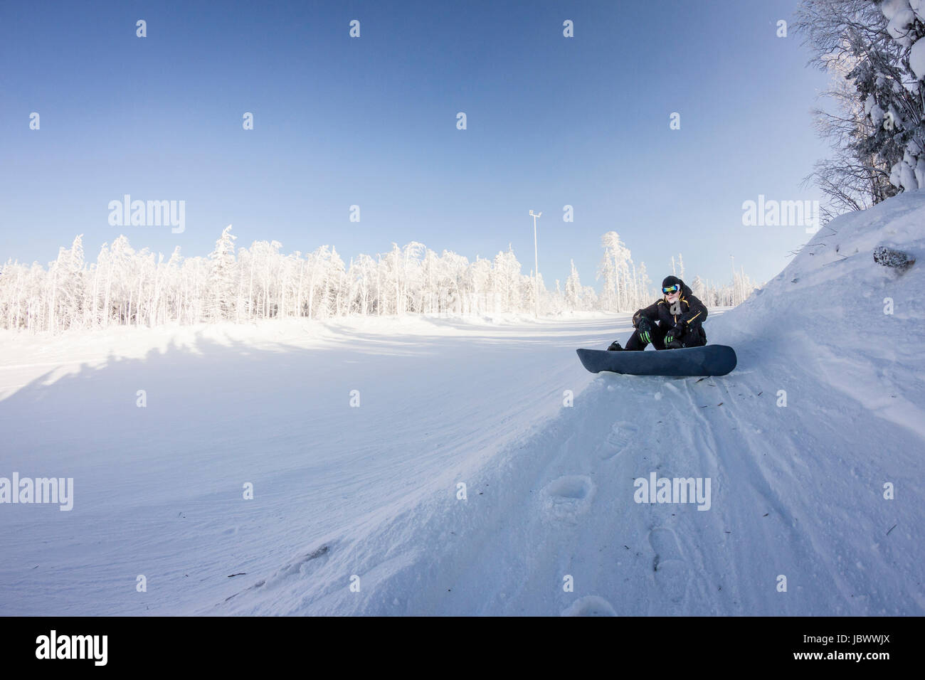 Skier resting in snow, Mount White, Sverdlovsk, Russia Stock Photo