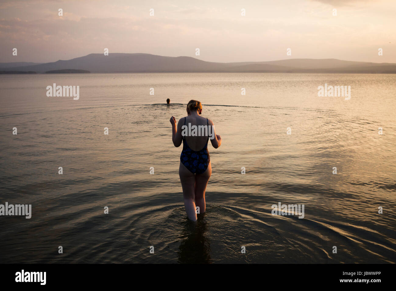 Woman walking in shallow water, Nizny Tagil, Russia Stock Photo