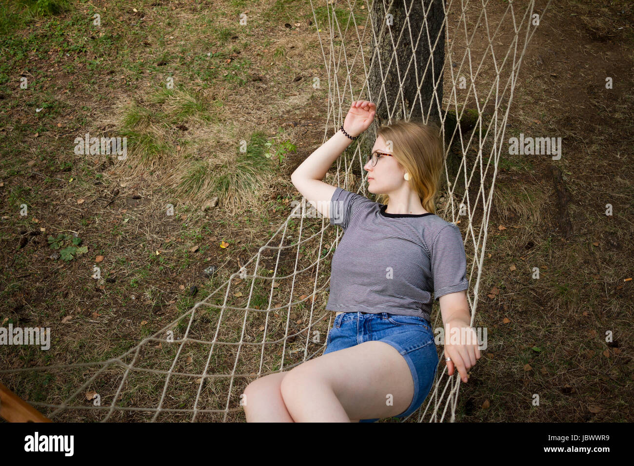 Woman resting in hammock Stock Photo