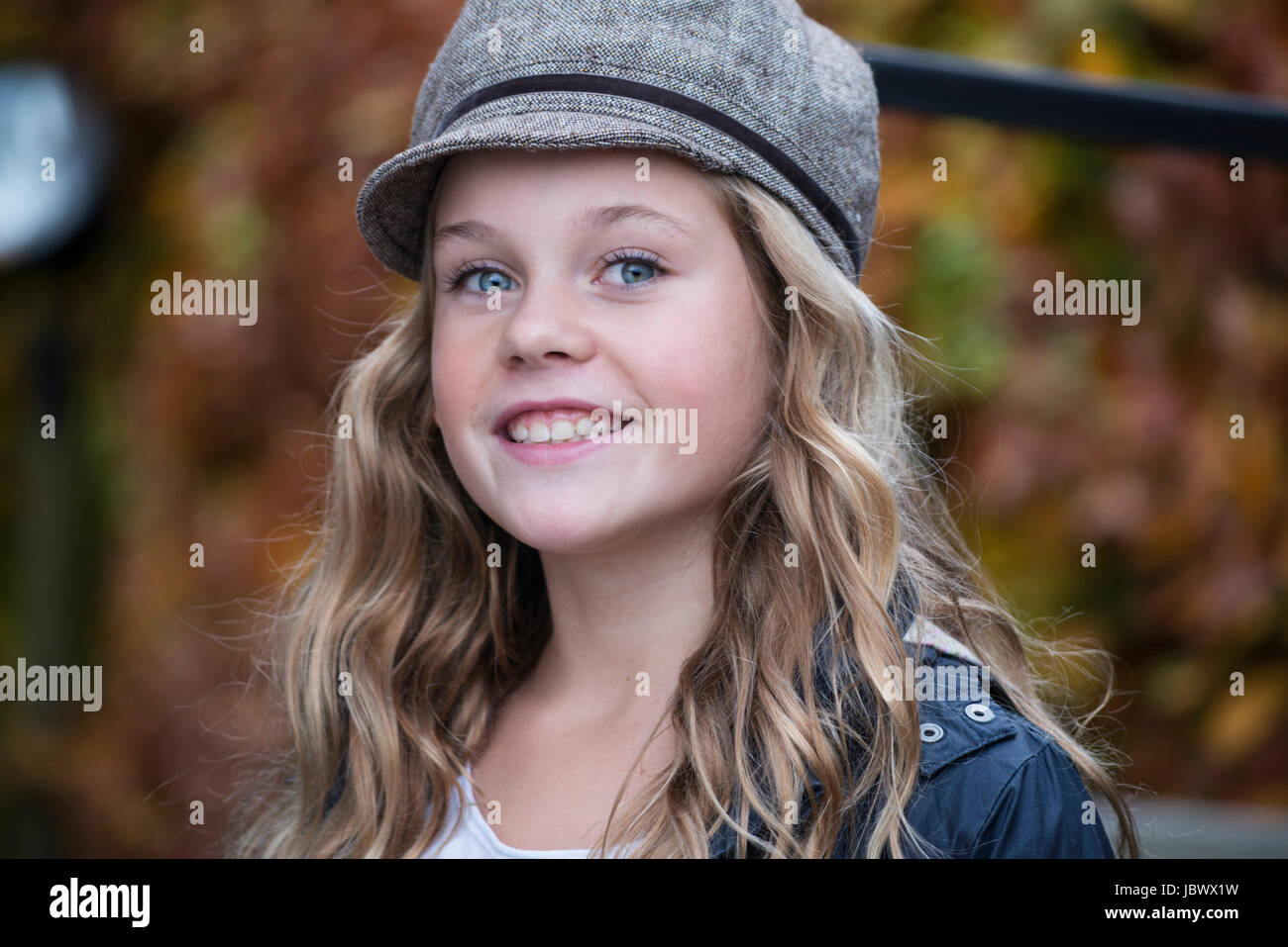 Portrait of blond girl in baker boy cap Stock Photo