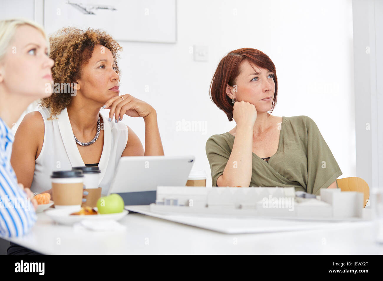 Female architect team listening during meeting Stock Photo