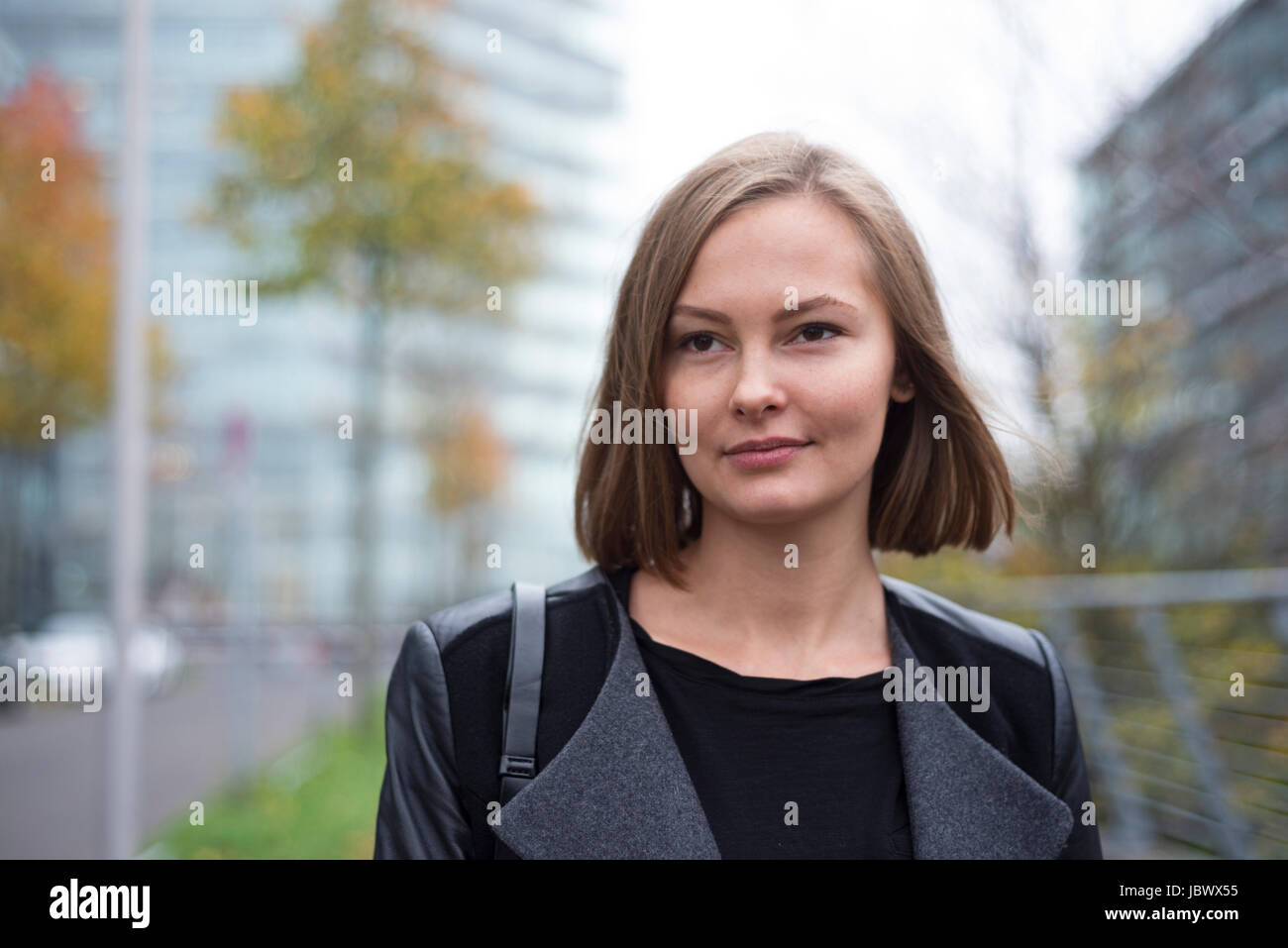 Young woman in city gazing Stock Photo