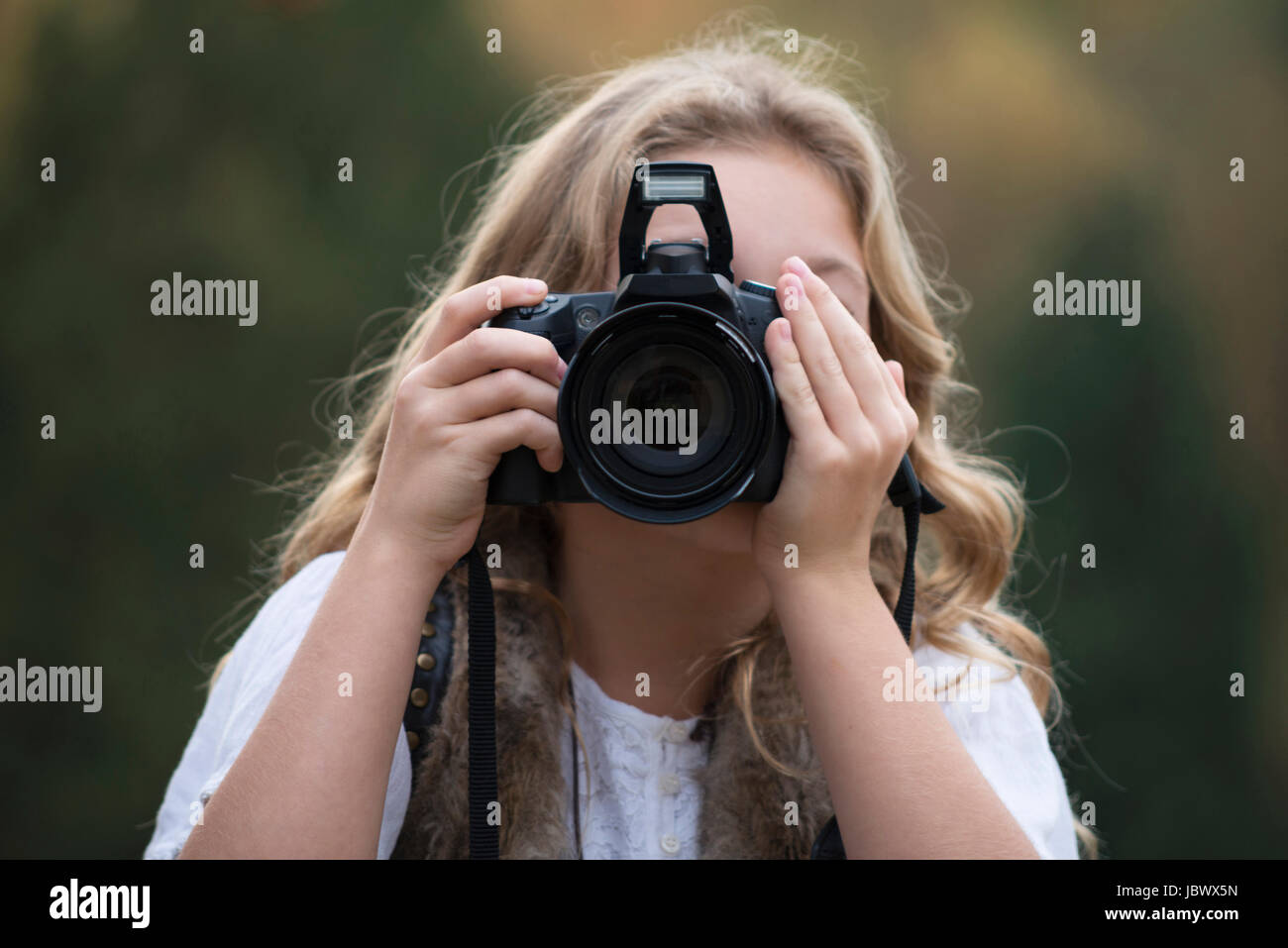 Portrait of girl taking photographs with digital SLR Stock Photo