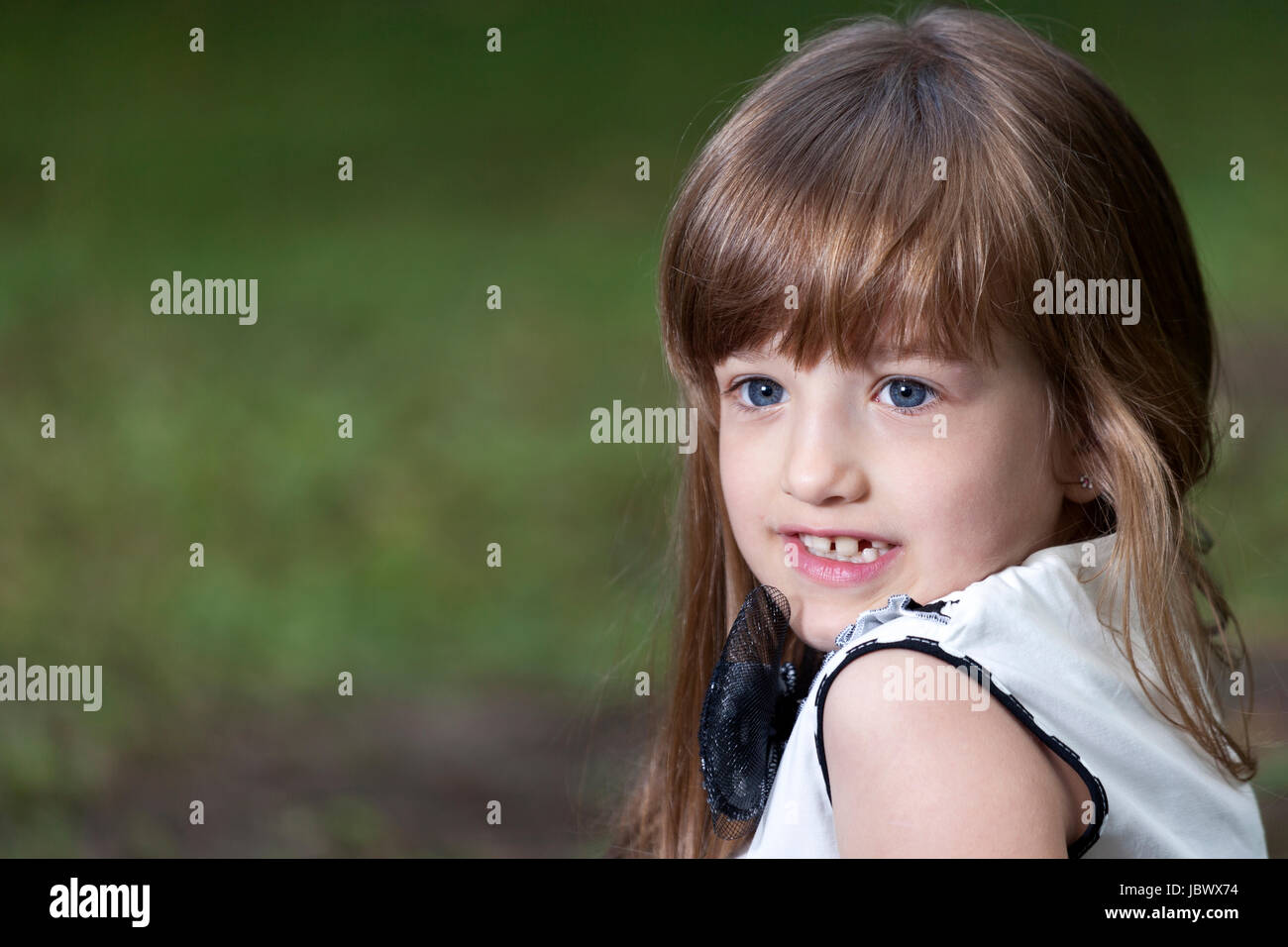 Portrait of a cute little girl with big blue eyes in the park Stock ...
