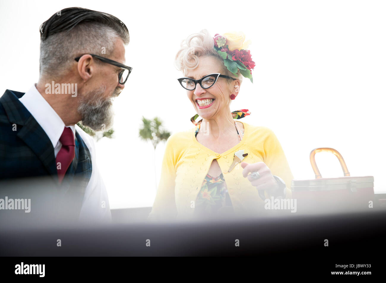 1950's vintage style couple laughing at coast Stock Photo