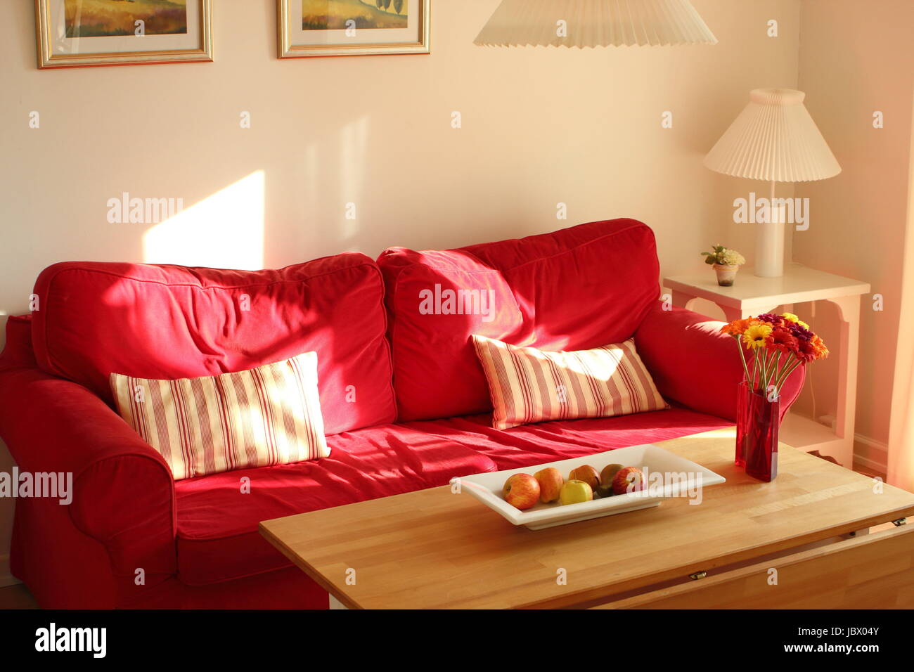 Cosy red couch in summerhouse in the afternoon Stock Photo Alamy