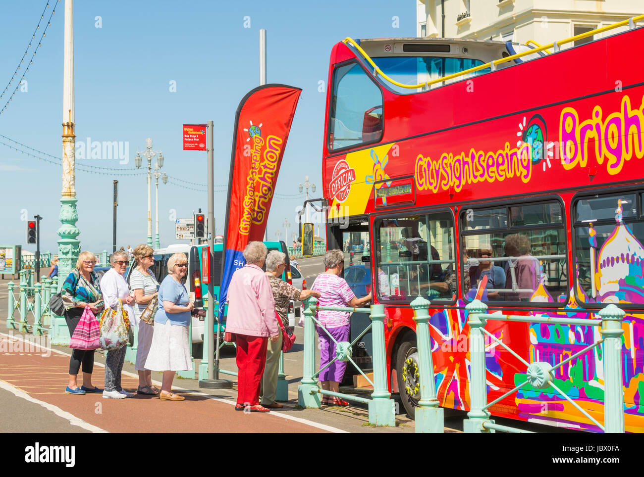 Sightseeing bus. Elderly tourists boarding the open top sightseeing bus on the seafront road in Brighton. East Sussex, England, UK. Stock Photo