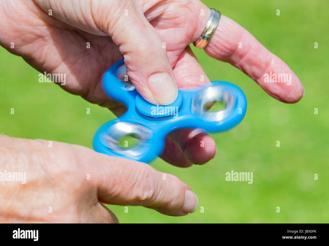 Playing with a fidget spinner. Stock Photo