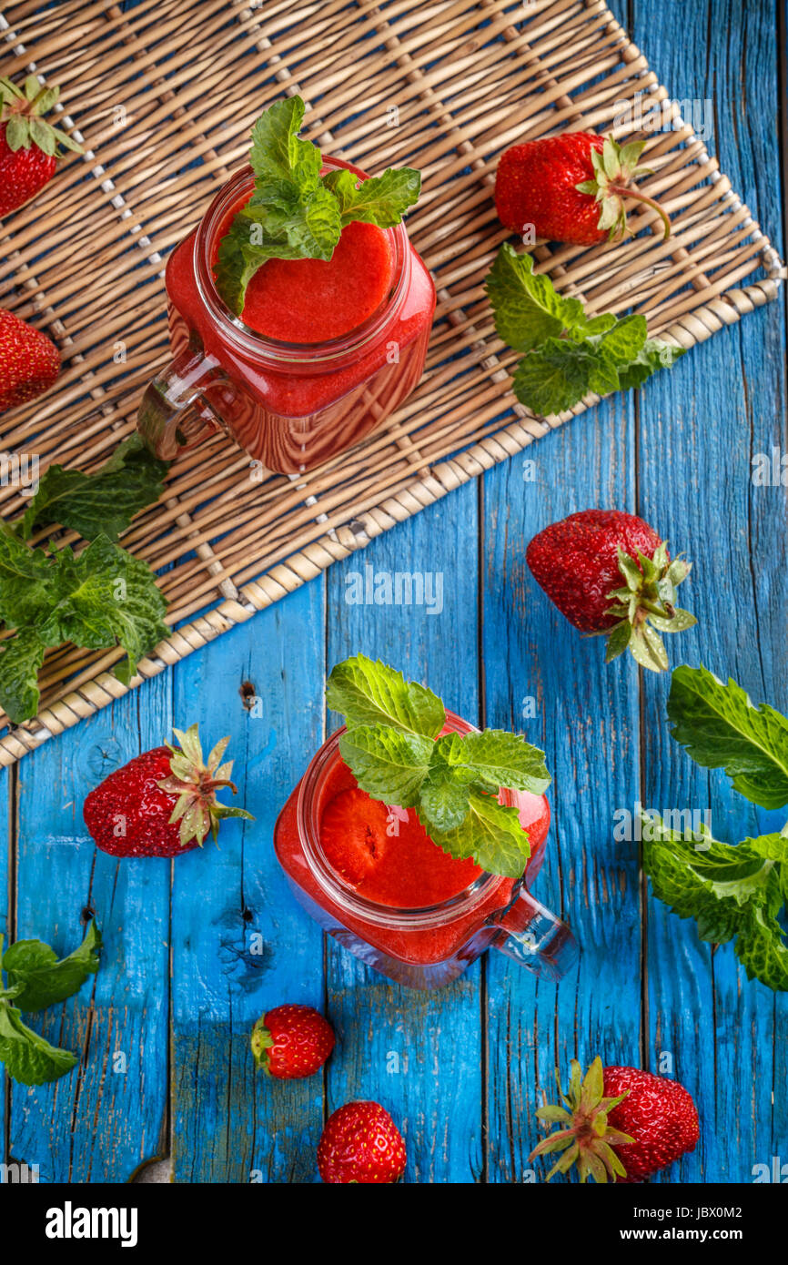 Still life of fresh strawberry smoothie in glass jars Stock Photo - Alamy