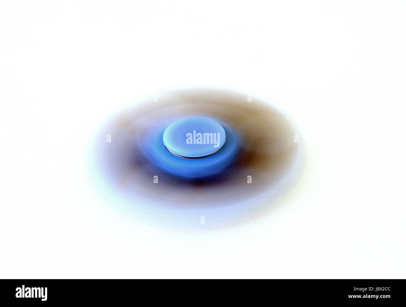 Blue fidget spinner spinning on white background Stock Photo