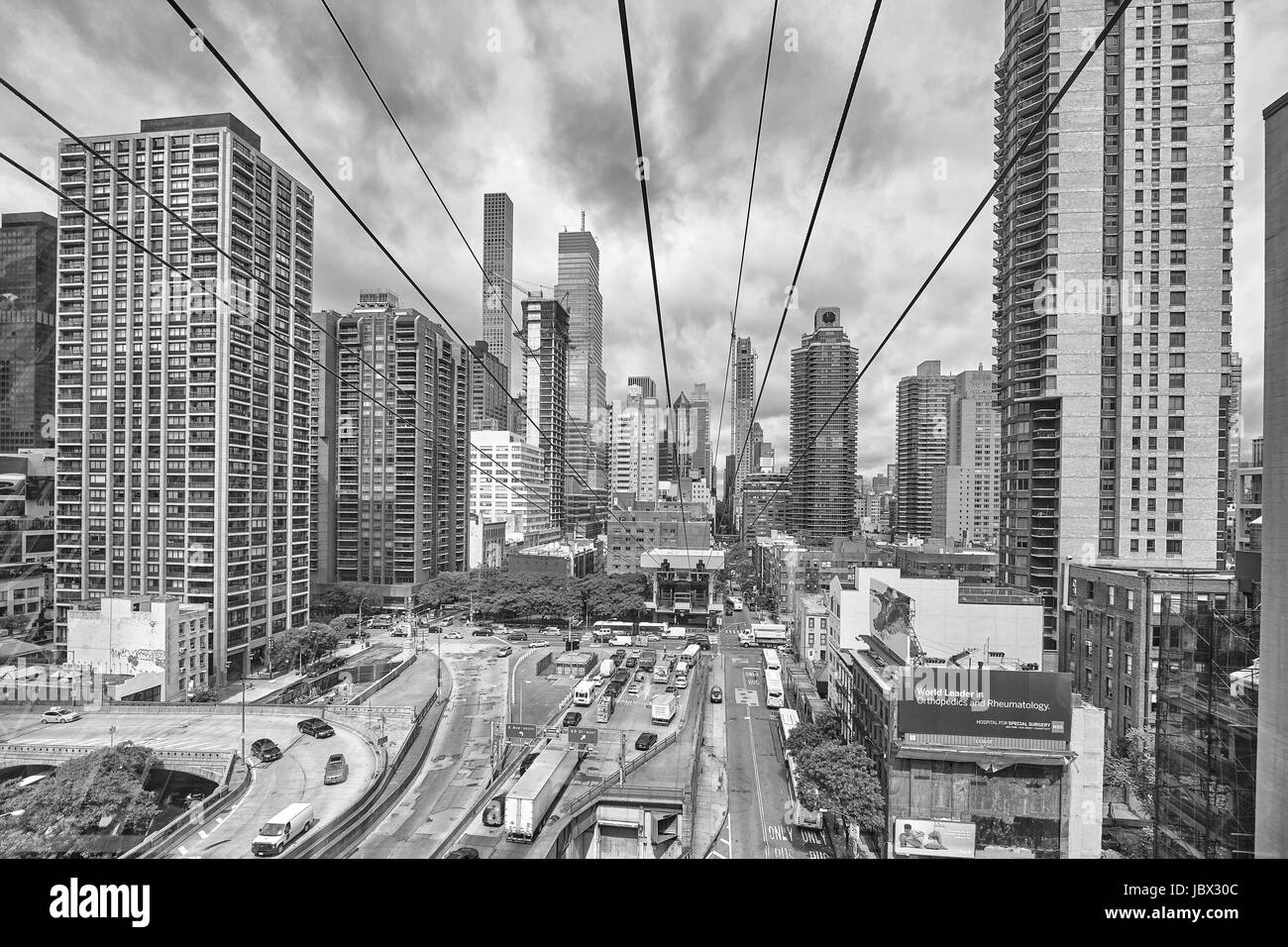 New York City, USA - May 26, 2017: Cloudy Manhattan seen from aerial tramway going to Roosevelt Island. Stock Photo