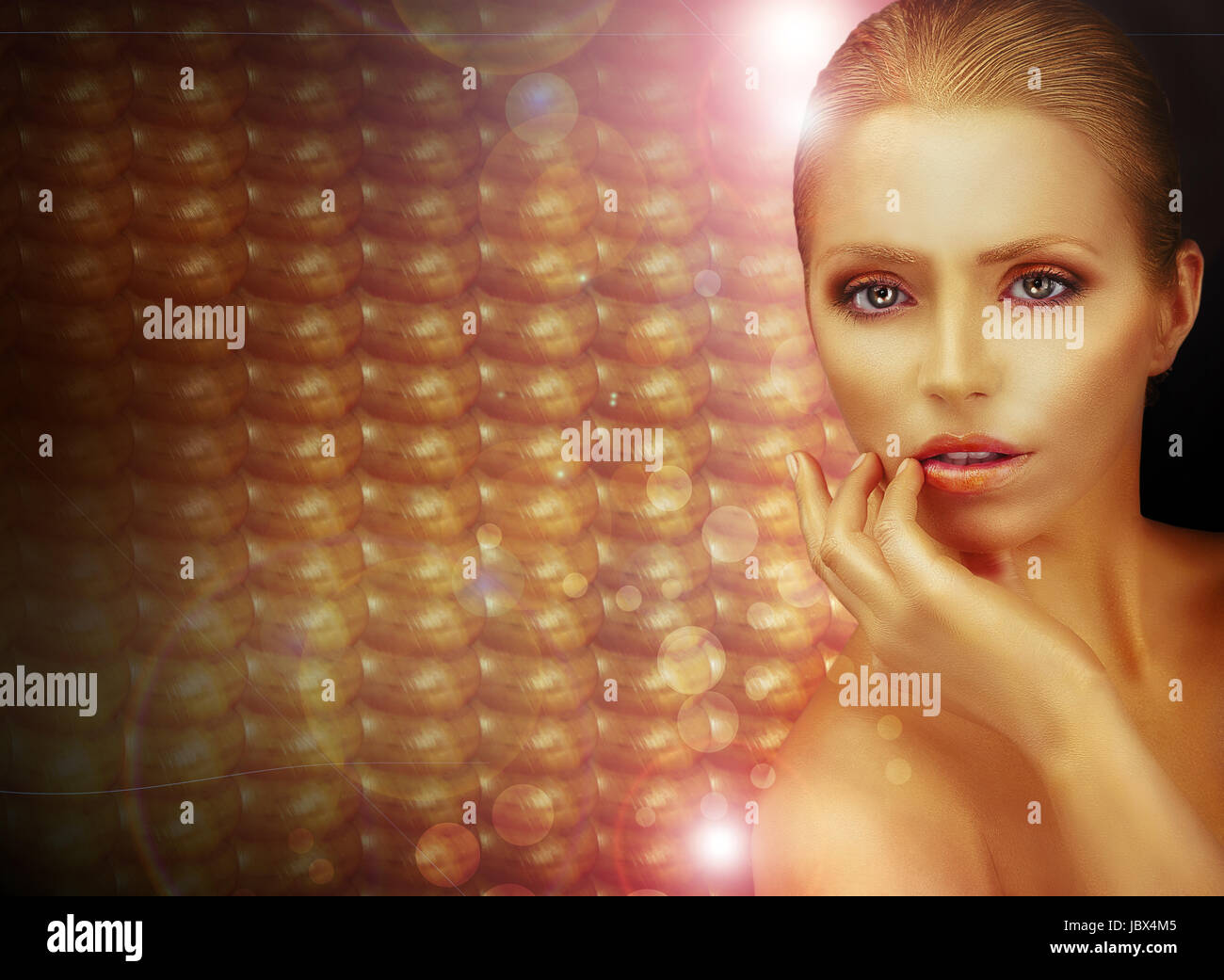 Fantasy. Beautiful Woman over Sparkling Gold Background Stock Photo