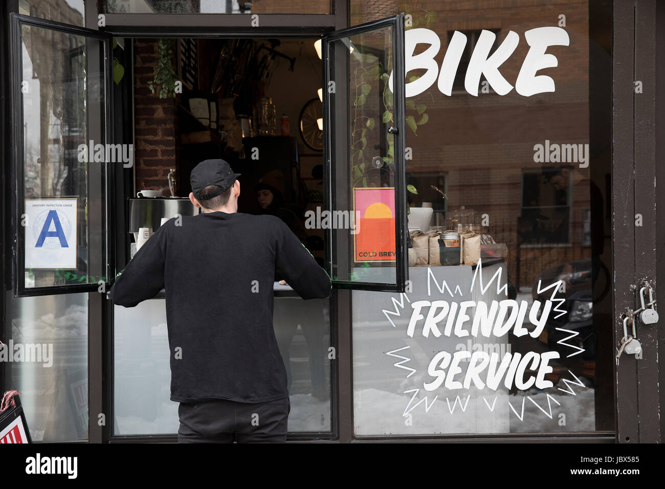 Customer at service window, Nike and Coffee shop, New York, USA Stock Photo