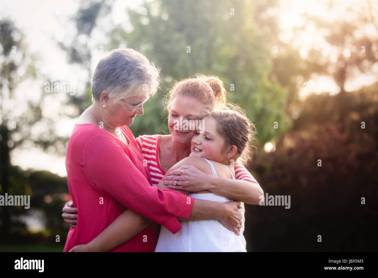 Portrait of three generation family, hugging Stock Photo