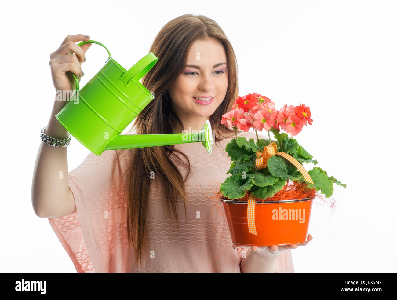 girl with potted plant and watering Stock Photo