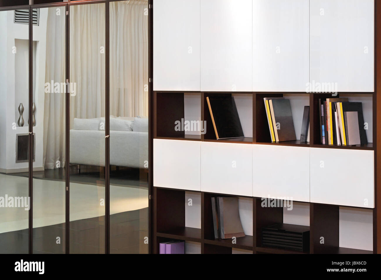 Bookshelf and wardrobe with mirror doors Stock Photo Alamy