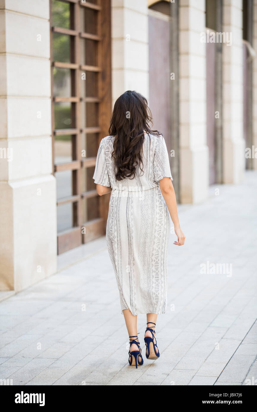 Rear view of a woman walking in the city Stock Photo - Alamy