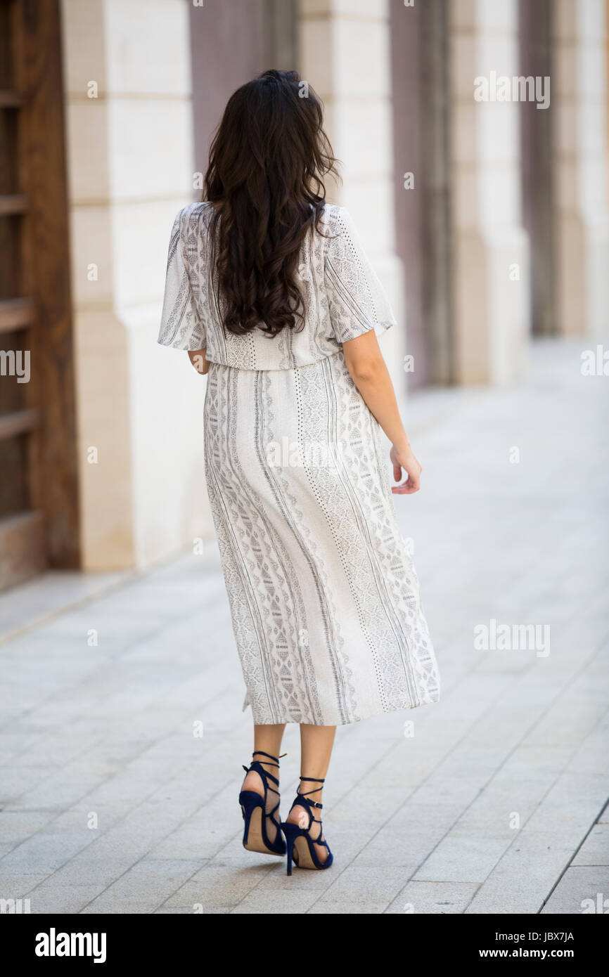 Rear view of a woman walking in the city Stock Photo - Alamy