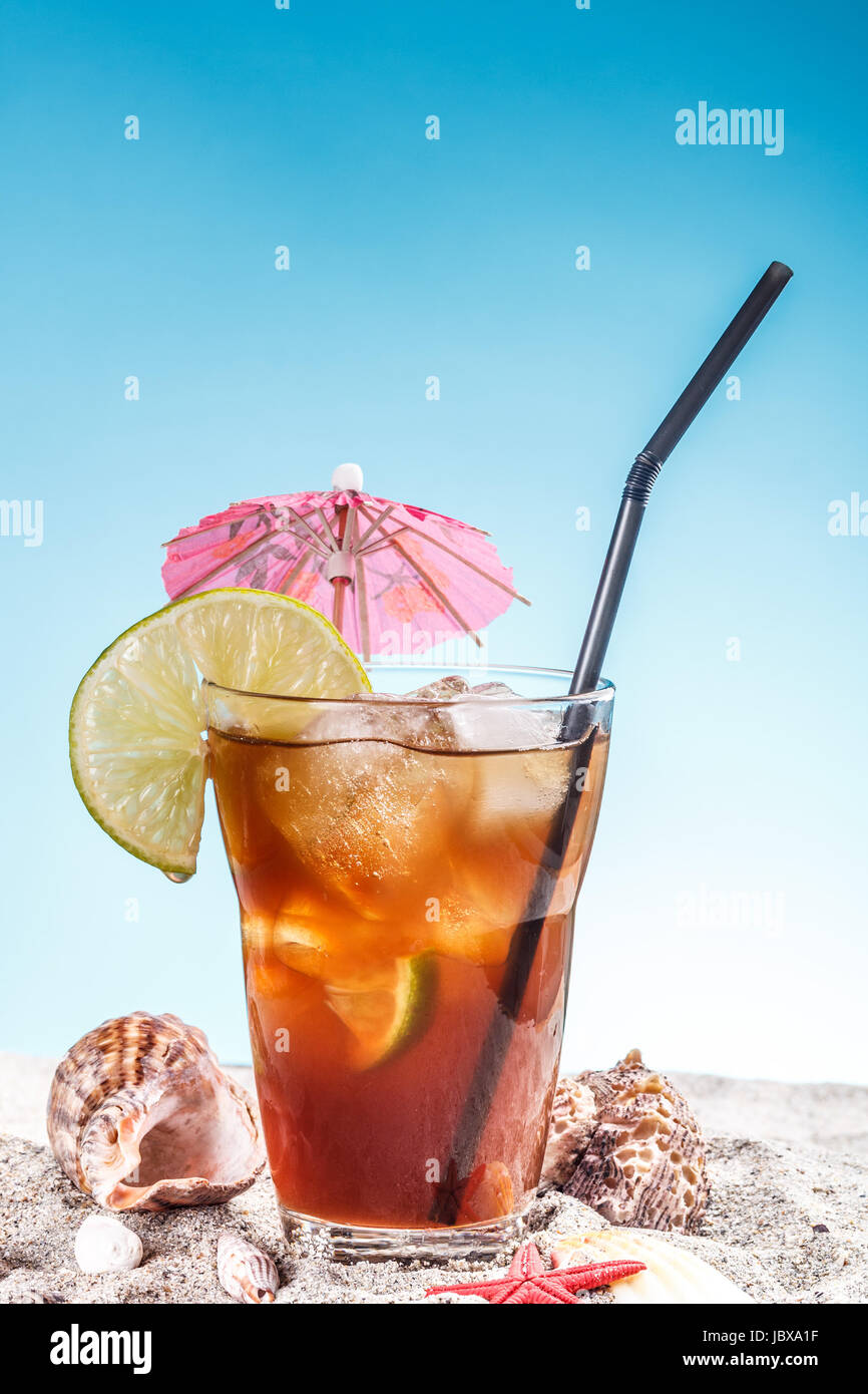 Ice tea with umbrella and straw Stock Photo - Alamy