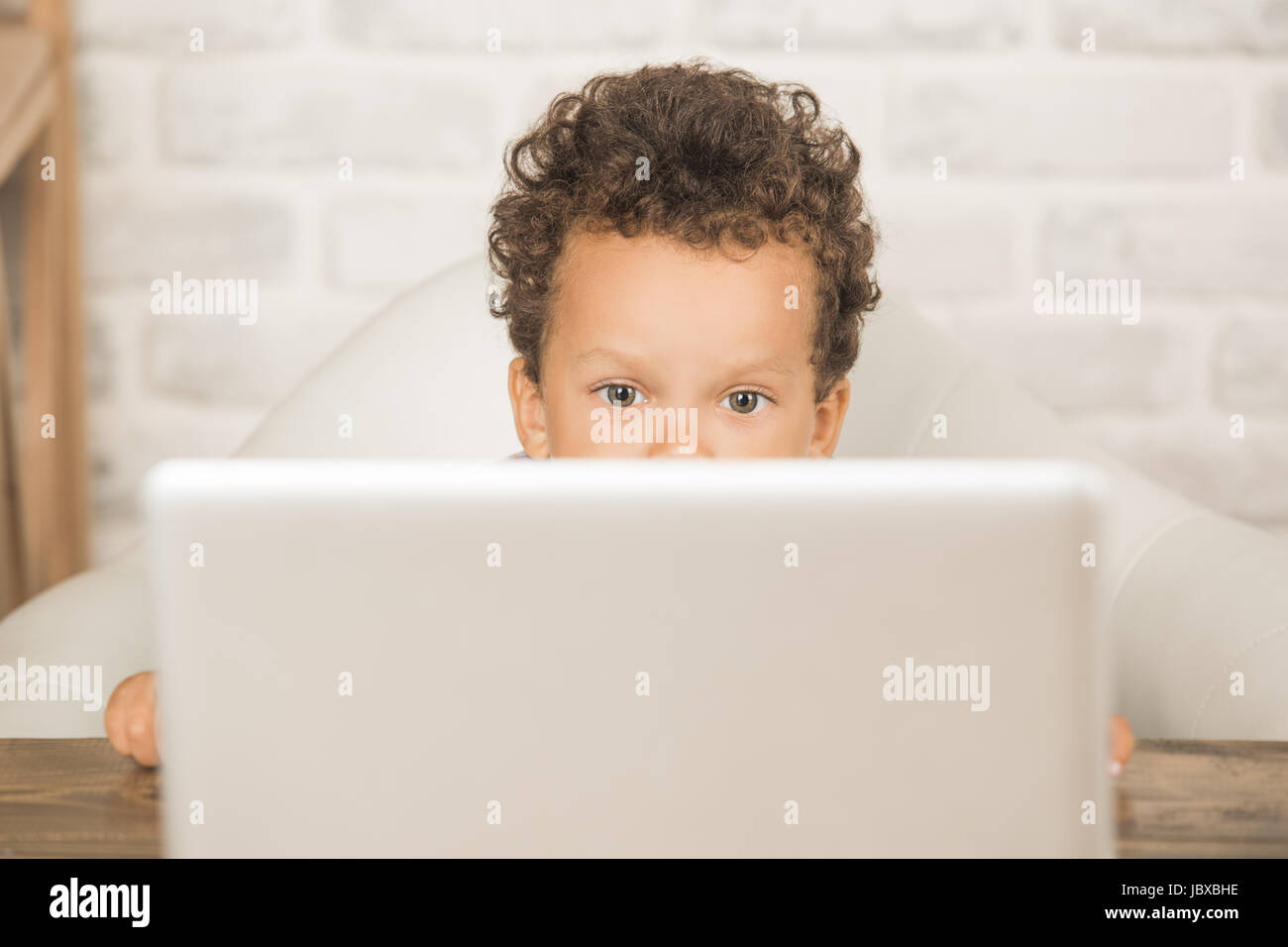 Little boy sitting using laptop modern technology Stock Photo - Alamy