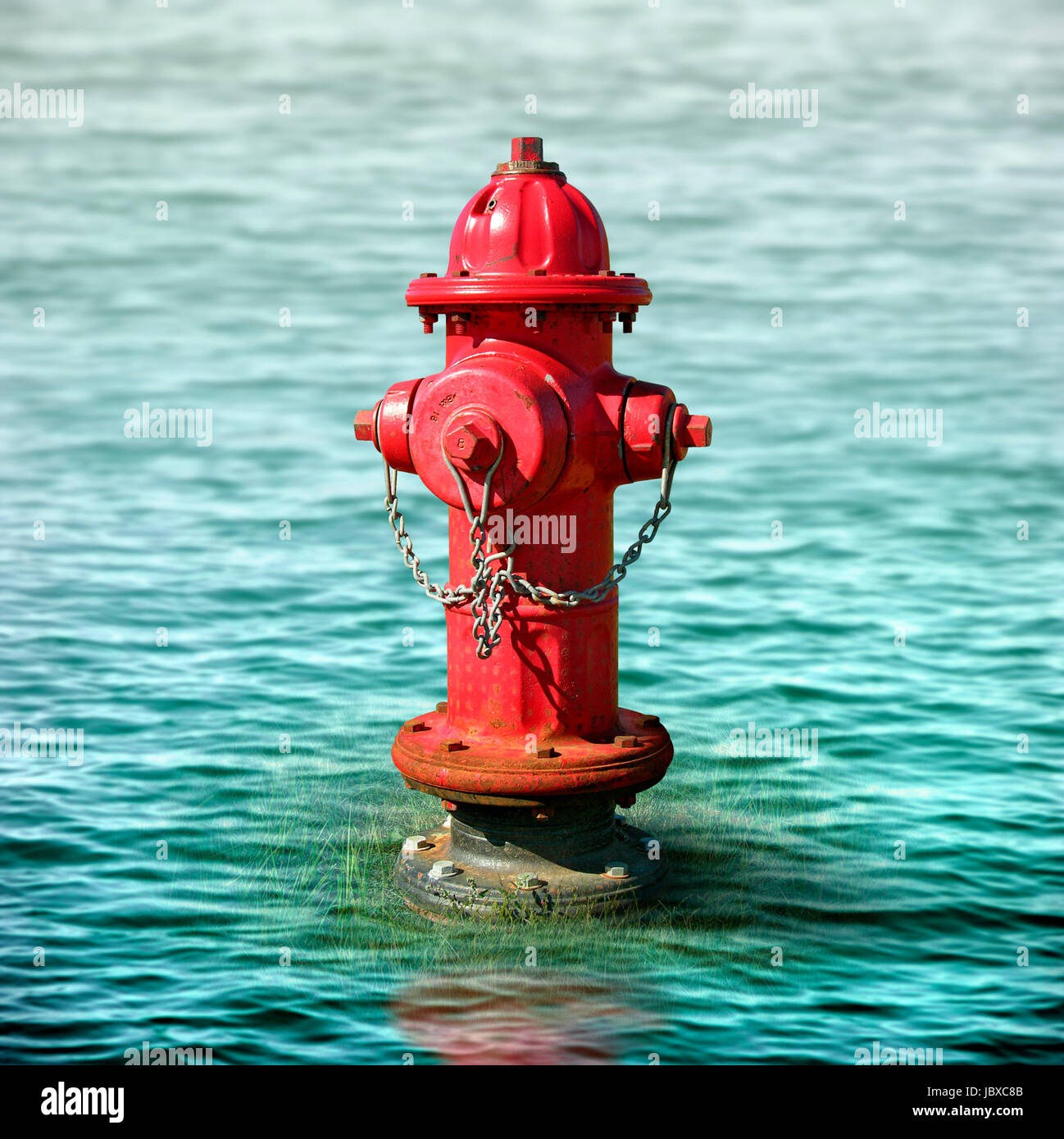 Photo illustration of a fire hydrant surrounded by flood waters. Stock Photo