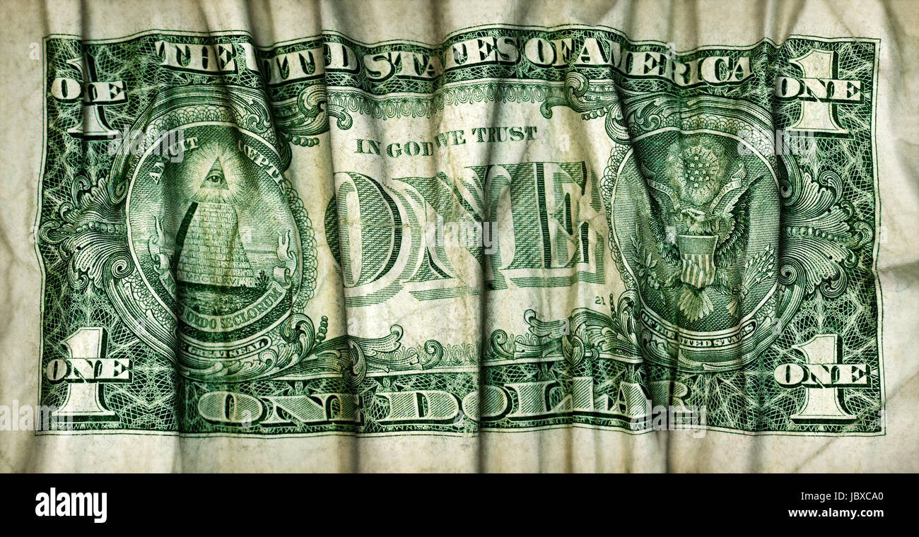 Back side of a U.S. one dollar bill that has been rolled and folded like a pleated drape. Stock Photo
