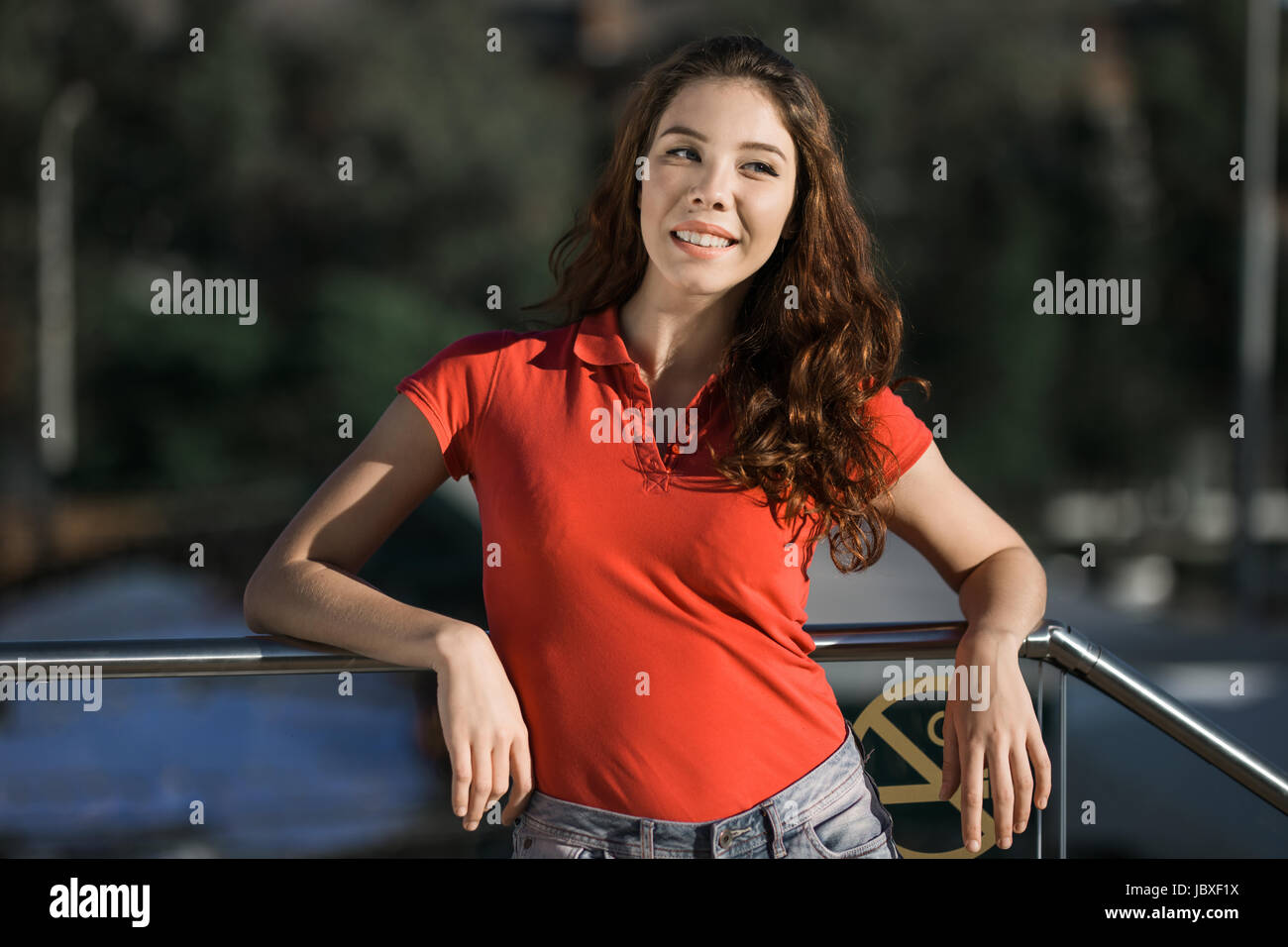 Summer sunny lifestyle fashion portrait of young woman posing in the city Stock Photo