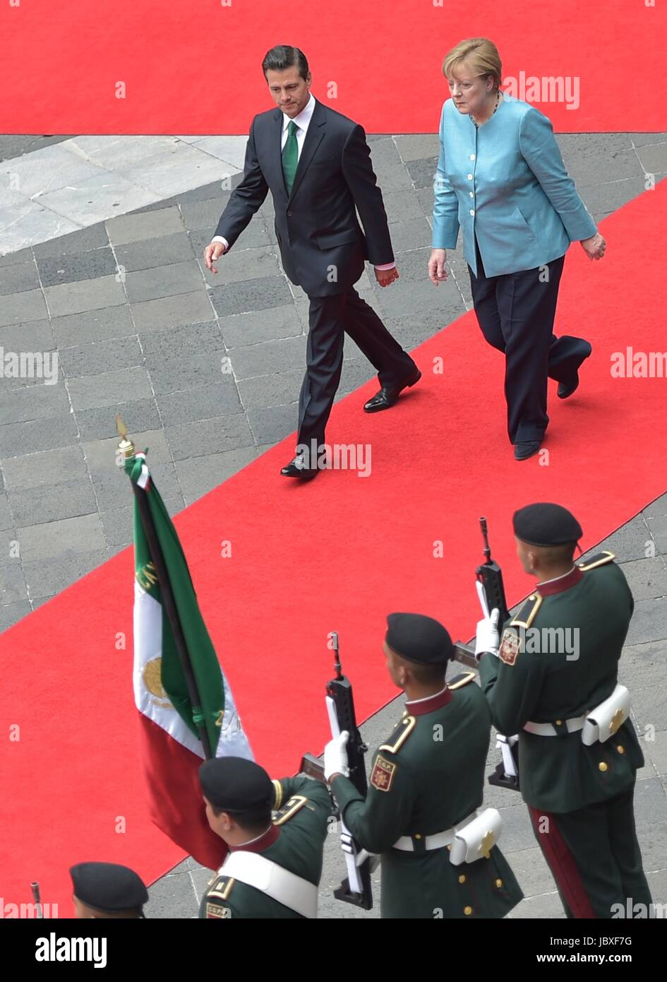Mexican President Enrique Pena Nieto escorts German Chancellor Angela Merkel for a review of the honor guard during the arrival ceremony at the National Palace at Los Pinos June 9, 2017 in Mexico City, Mexico. Stock Photo
