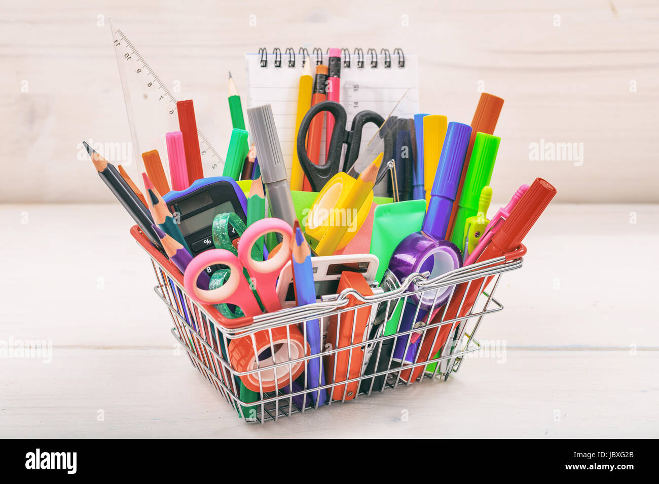 School supplies in a shopping basket on white background Stock Photo Alamy