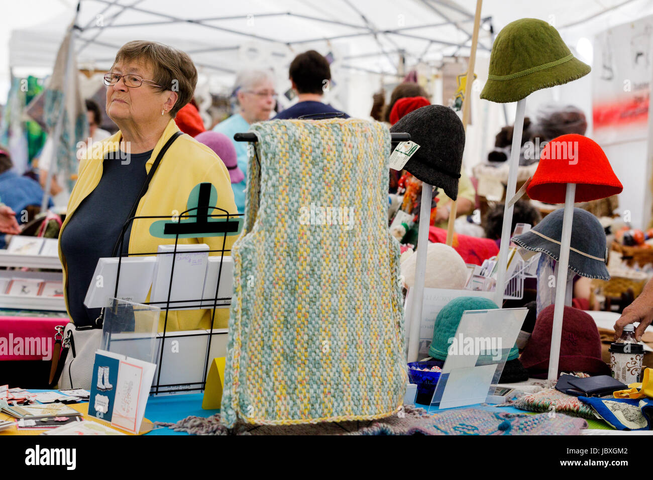 BOUCKVILLE, NY, USA - JUNE 10 2017: Hand made and hand dyed wool vest and hats for sale at the annual Fiber Festival of Central New York. Stock Photo