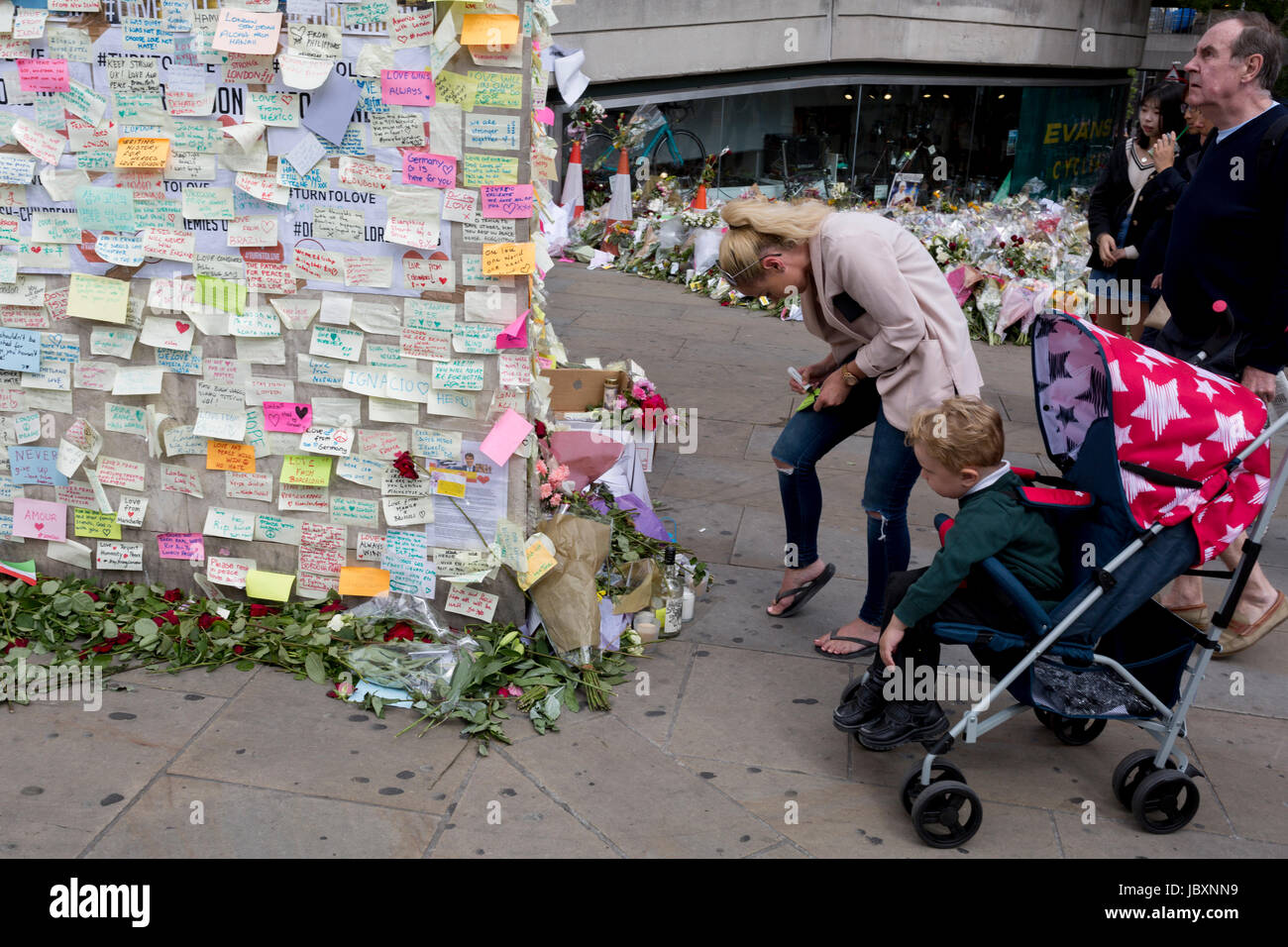 A shrine of flowers and compassionate messages continue to grow ten days after the terrorist attack on London Bridge and Borough Market, on 12th June 2017 in London, England. Near the southern-most boundary of the City of London opposite to the attack location, Londoners and visitors to the capital leave their emotional and defiant poems and personal messages on post-it notes. Stock Photo