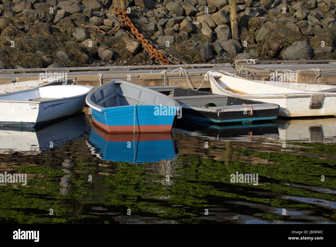 Dories tied to the fishing pier at Perkins Cove, Ogunquit, Maine. These small boats are used by