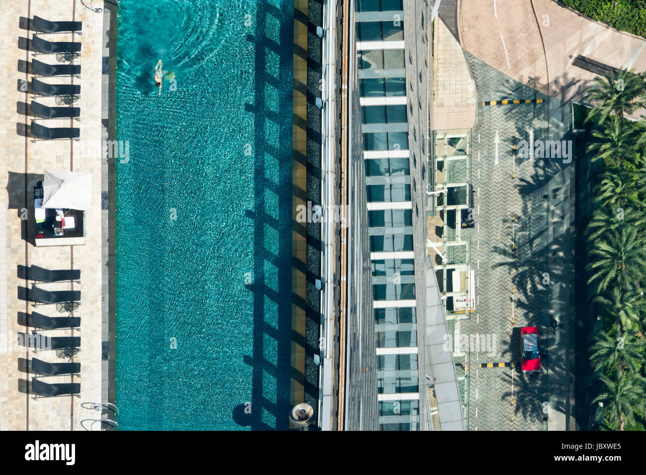Horizontal aerial view of a rooftop swimming pool at a hotel in Hong Kong, China. Stock Photo