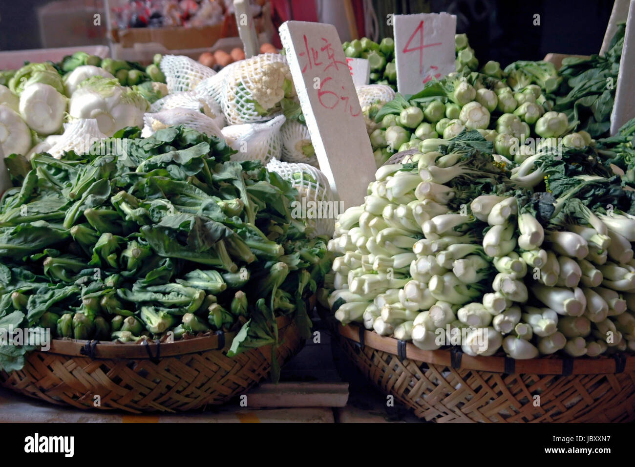 Horizontal close up of piles of fresh Chinese vegetables, Pak Choi, Choy Sum and chinese leaves for sale at an open air market in Hong Kong. Stock Photo