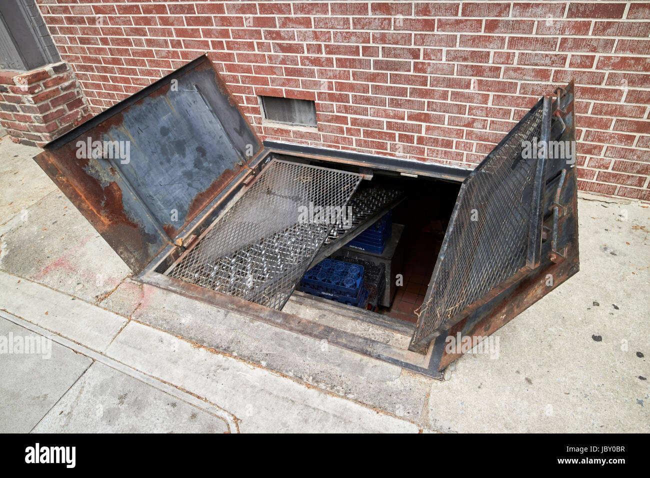 open gate cellar access known as beer drop for deliveries to building in sidewalk street Philadelphia USA Stock Photo