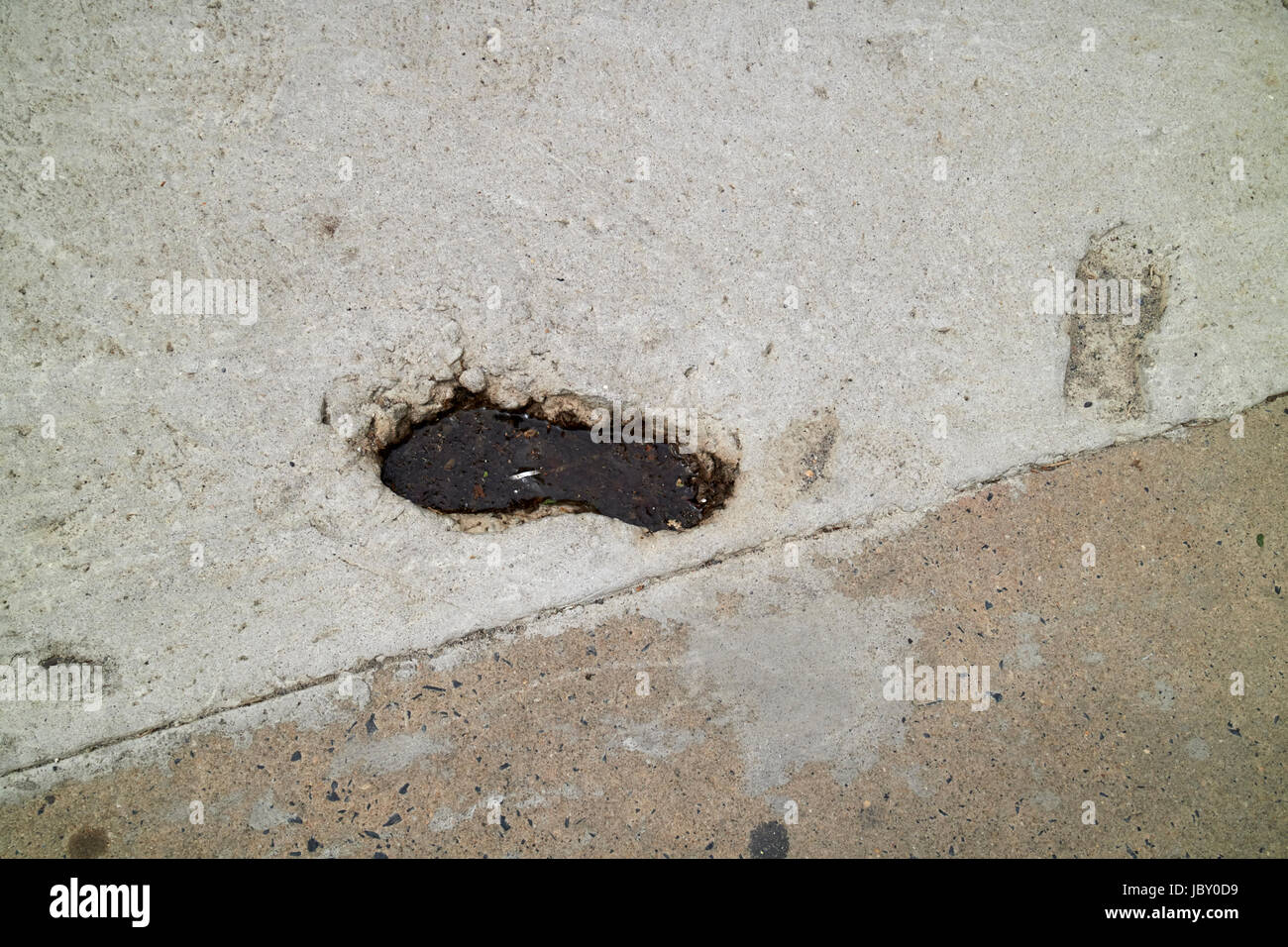 footsteps buried in sidewalk concrete Philadelphia USA Stock Photo